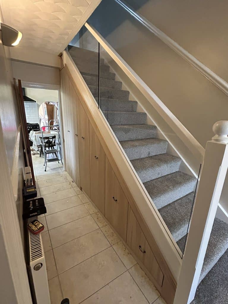 A new staircase accompanied by stylish storage drawers.